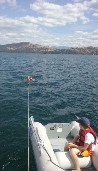 Part of the fun of sailing on Flathead Lake with kids is being pulled along on the rope behind the boat.